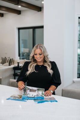 Alexis reviewing open house flyers for homes in Orlando, Florida during a property tour.