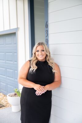 Alexis Bress, a trusted Central Florida real estate agent, standing outside a home during a showing